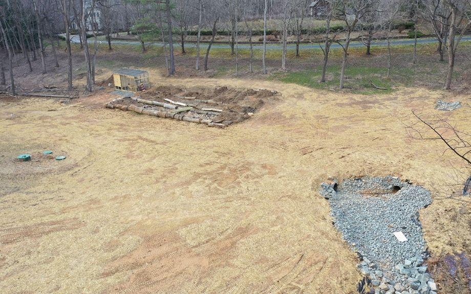 Grading changes to a Virginia yard by Riverbend Landscapes to prevent flooding issues.